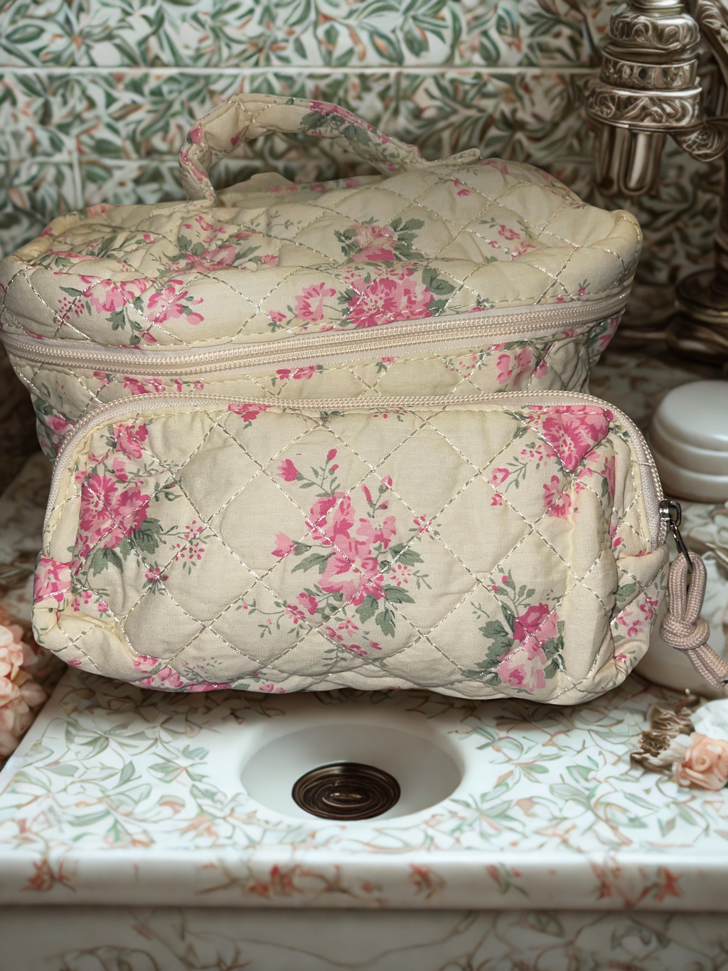 4-piece quilted floral cosmetic bag set styled in a vintage bathroom