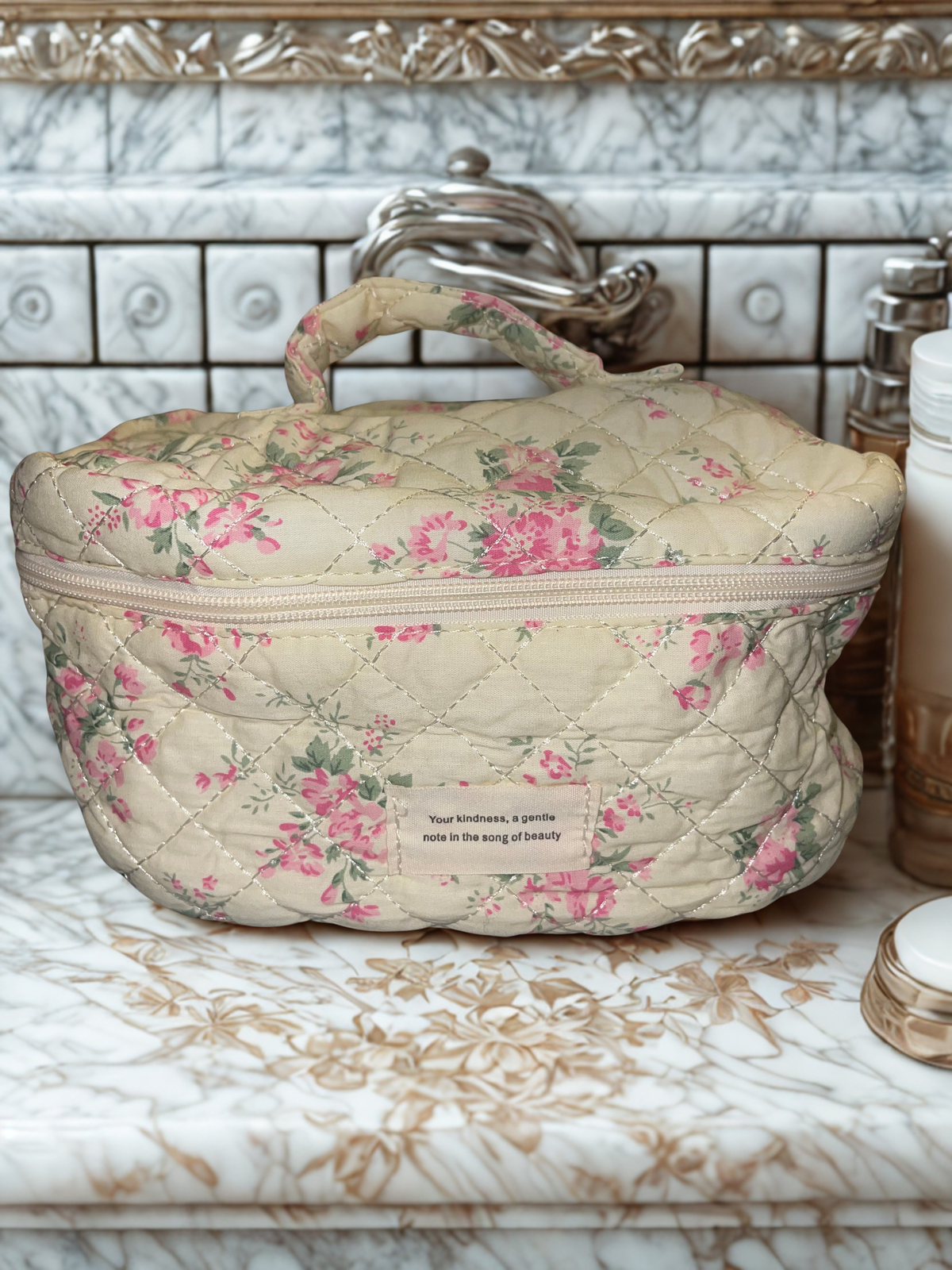 Large train case and medium pouch side by side on marble counter