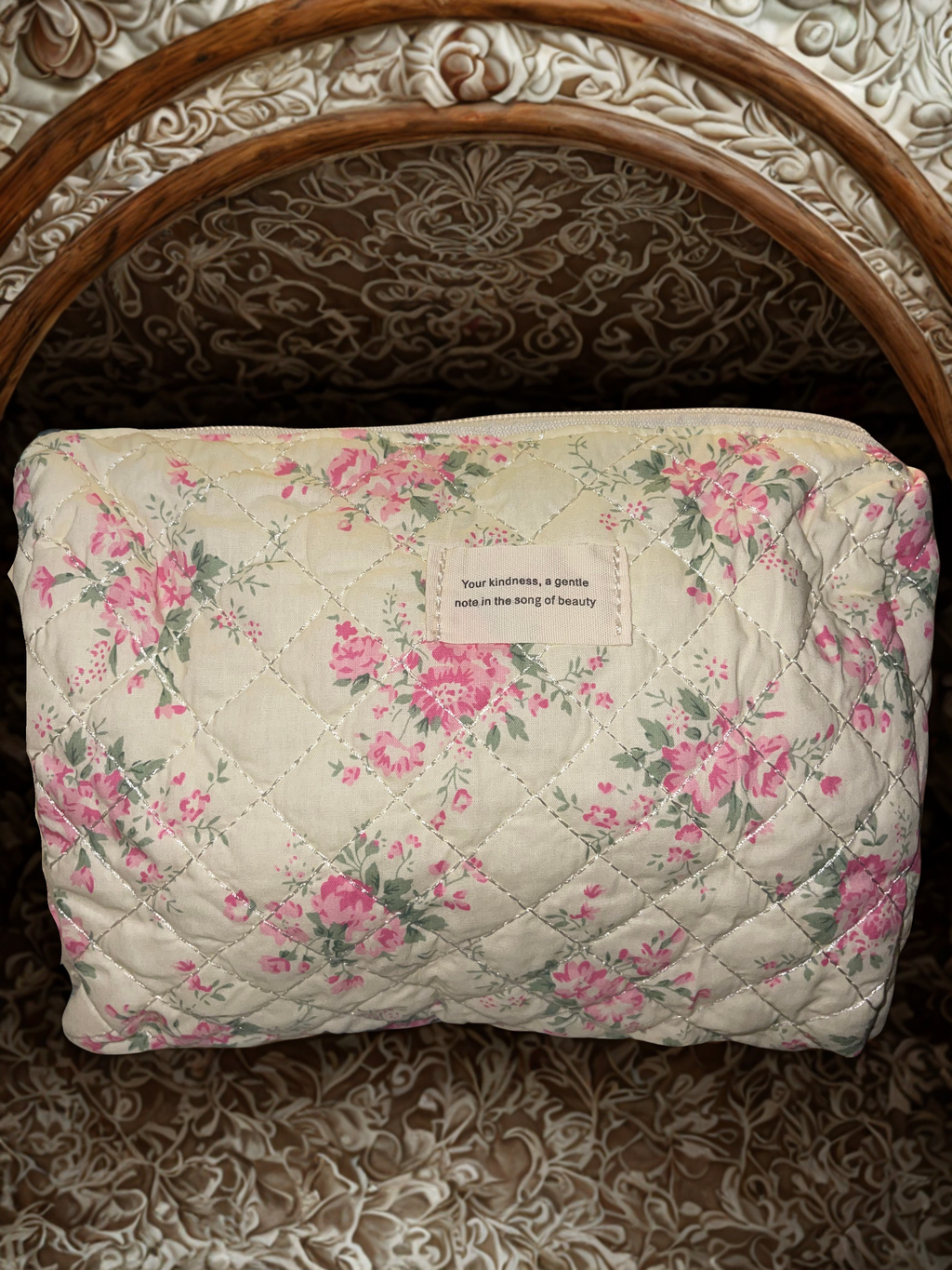 Quilted floral cosmetic bag set flat lay showing all four pieces