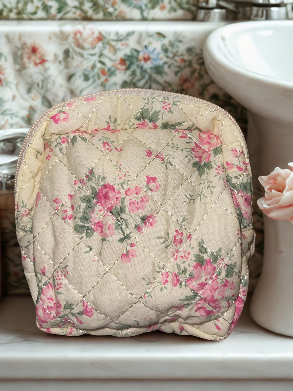 Large quilted floral train case on marble vanity counter
