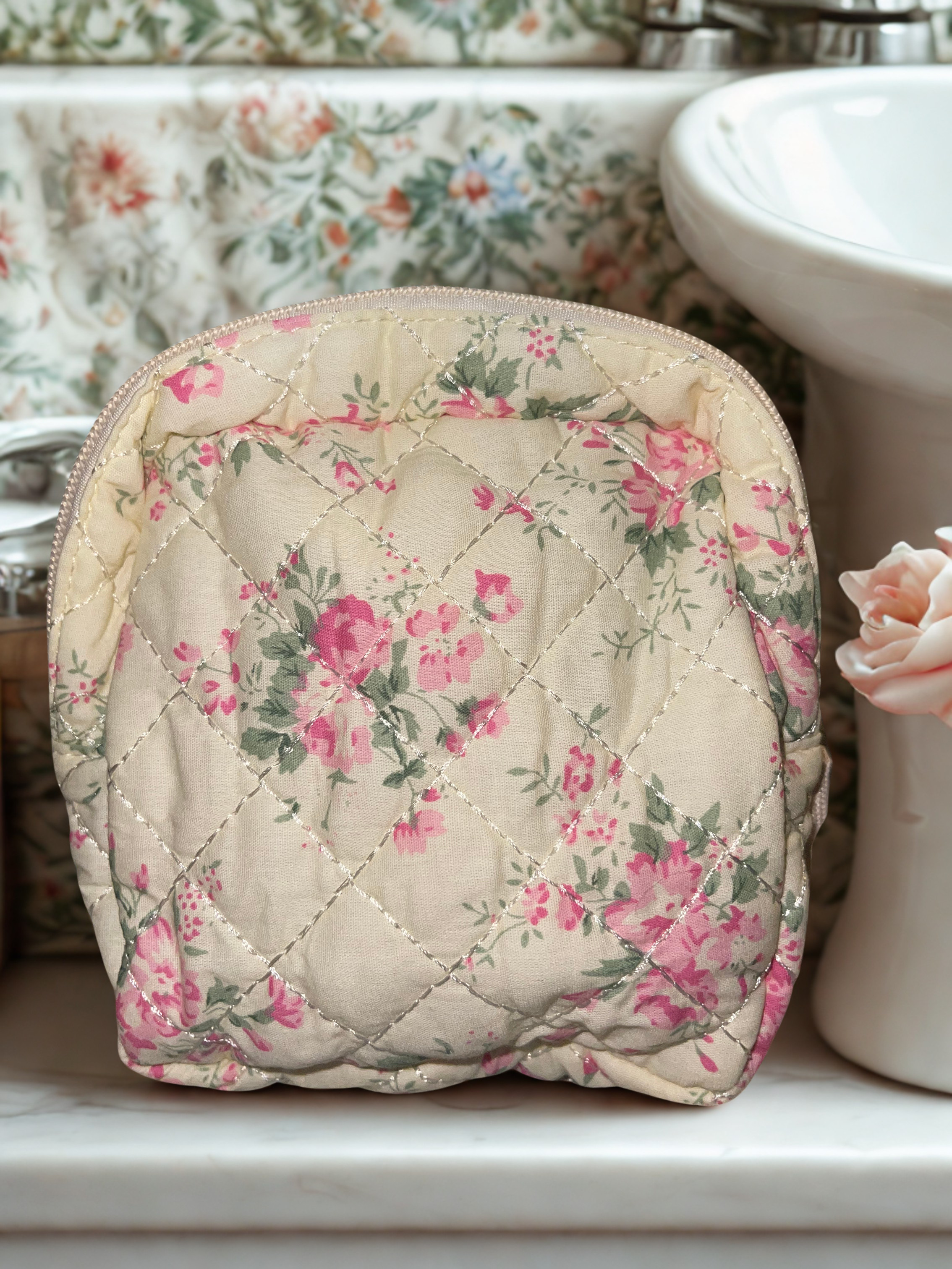 Large quilted floral train case on marble vanity counter