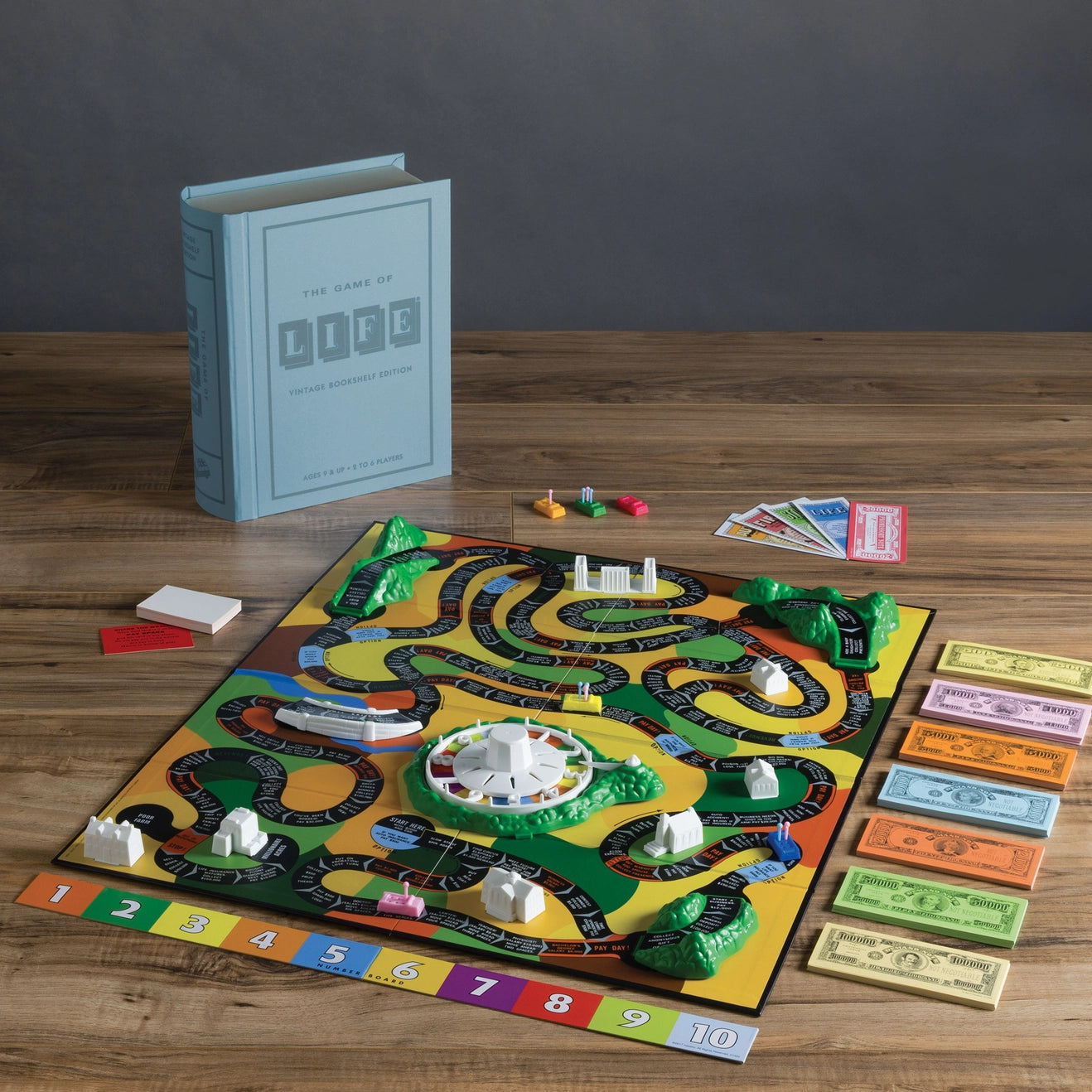 The Game of Life Vintage Bookshelf Edition - complete game components flat lay on white background