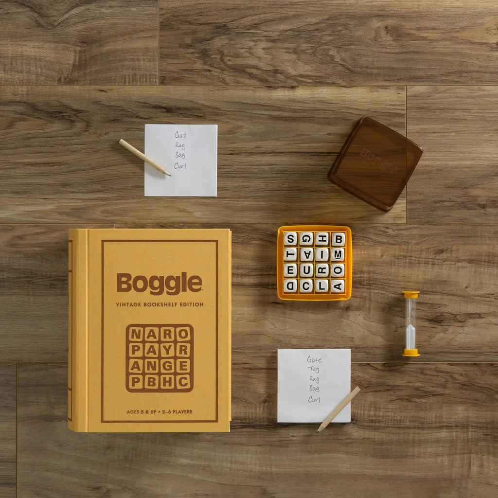 Boggle Vintage Bookshelf Edition - game box standing with components displayed on wood floor
