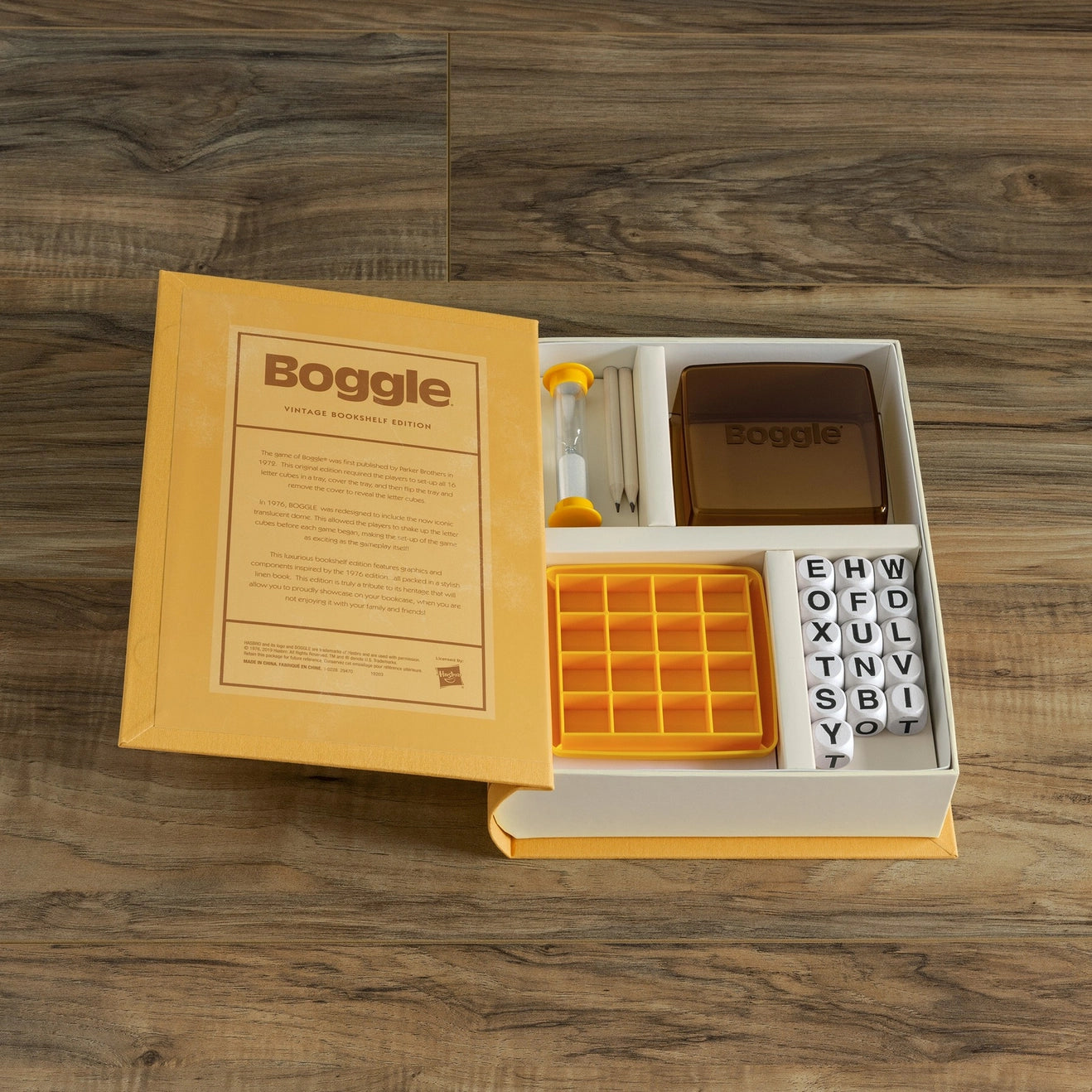 Boggle Vintage Bookshelf Edition - flat lay of game components on wood floor