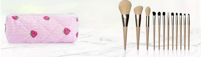 Small strawberry quilted pencil bag shown with makeup brushes