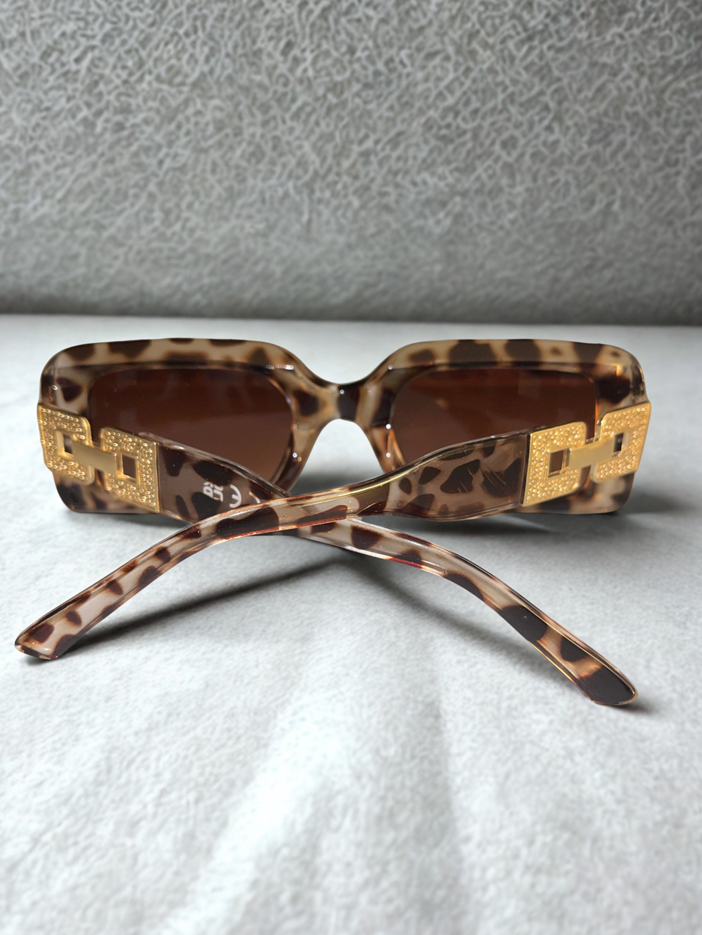 Wild Luxe Rectangle Sunglasses back view showing gold chain hardware
