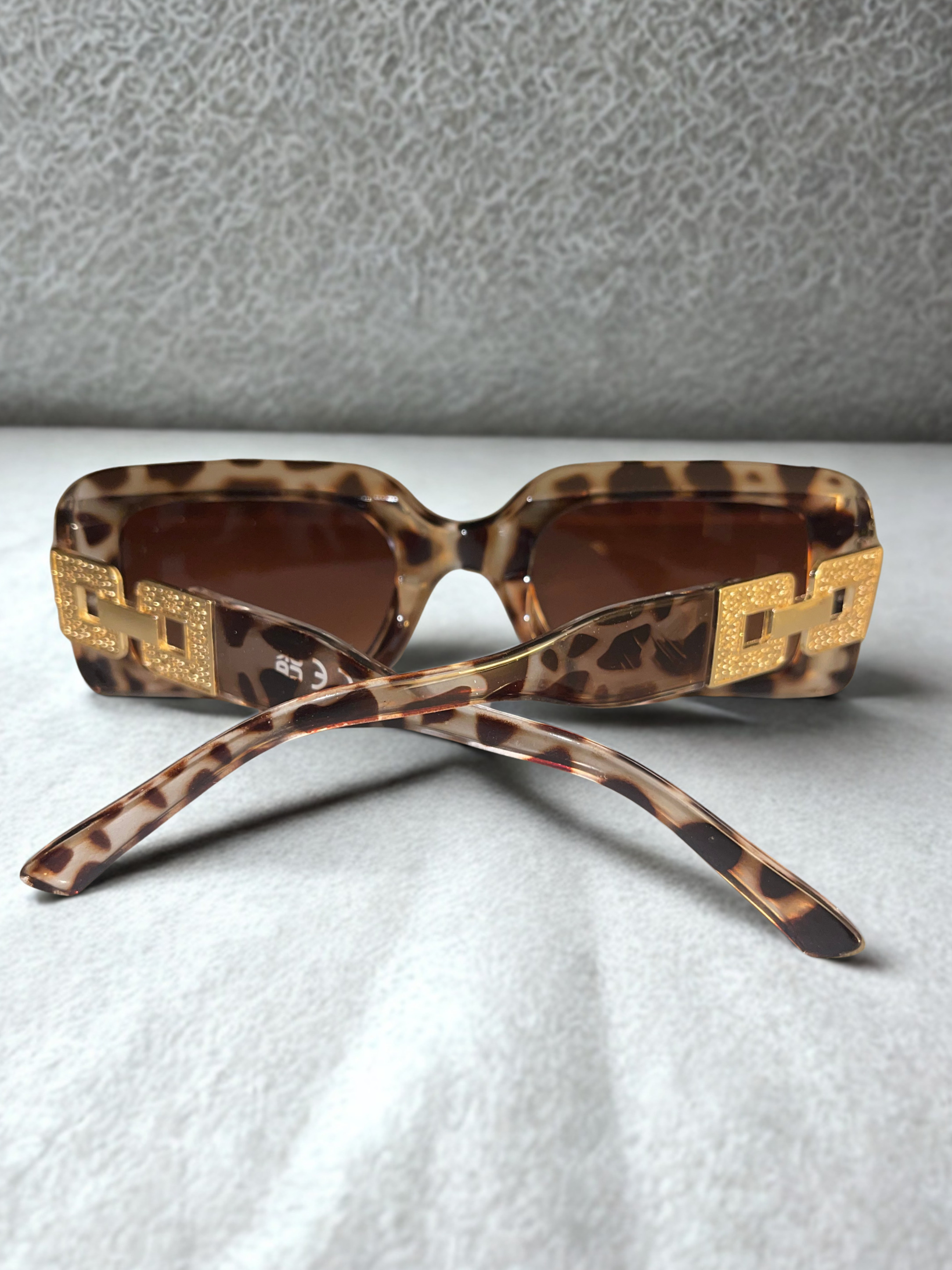 Wild Luxe Rectangle Sunglasses back view showing gold chain hardware
