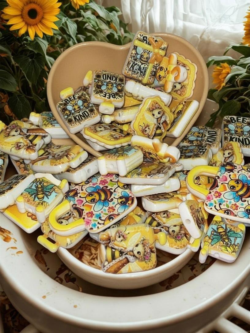 Honey bee bead charms in tan heart bowl with sunflowers