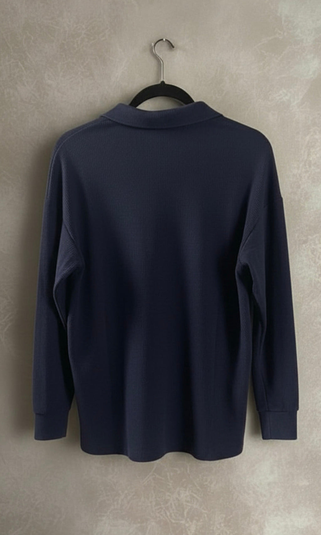 Loose lapel buttoned top on hanger - navy blue front view
