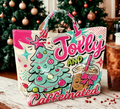Jolly and Caffeinated tote bag styled next to iced coffee on a Christmas decorated table