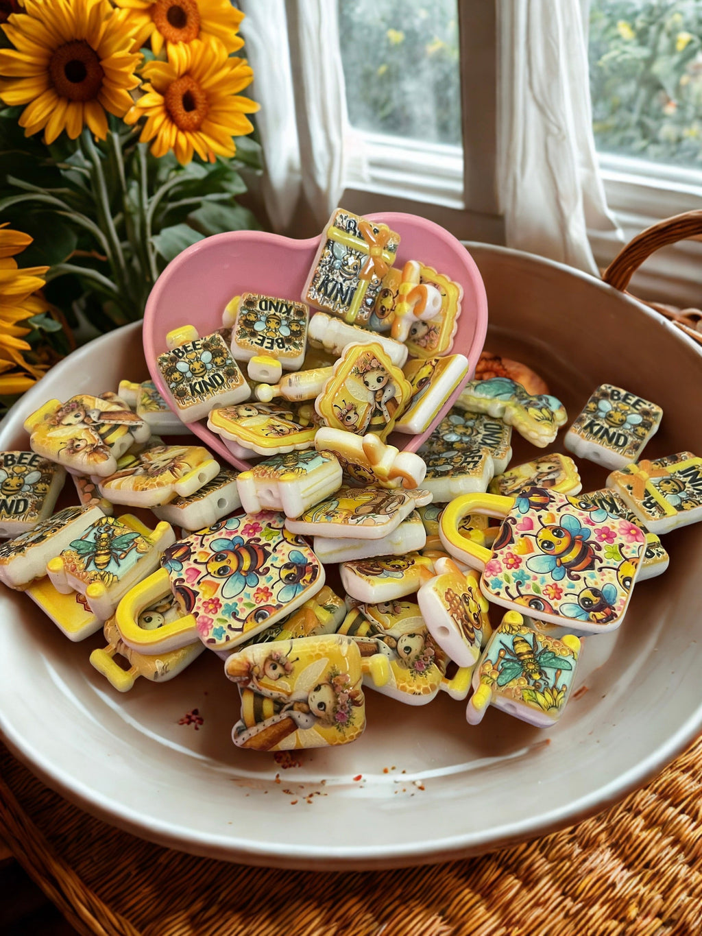 Honey bee bead charms in pink heart bowl with sunflowers