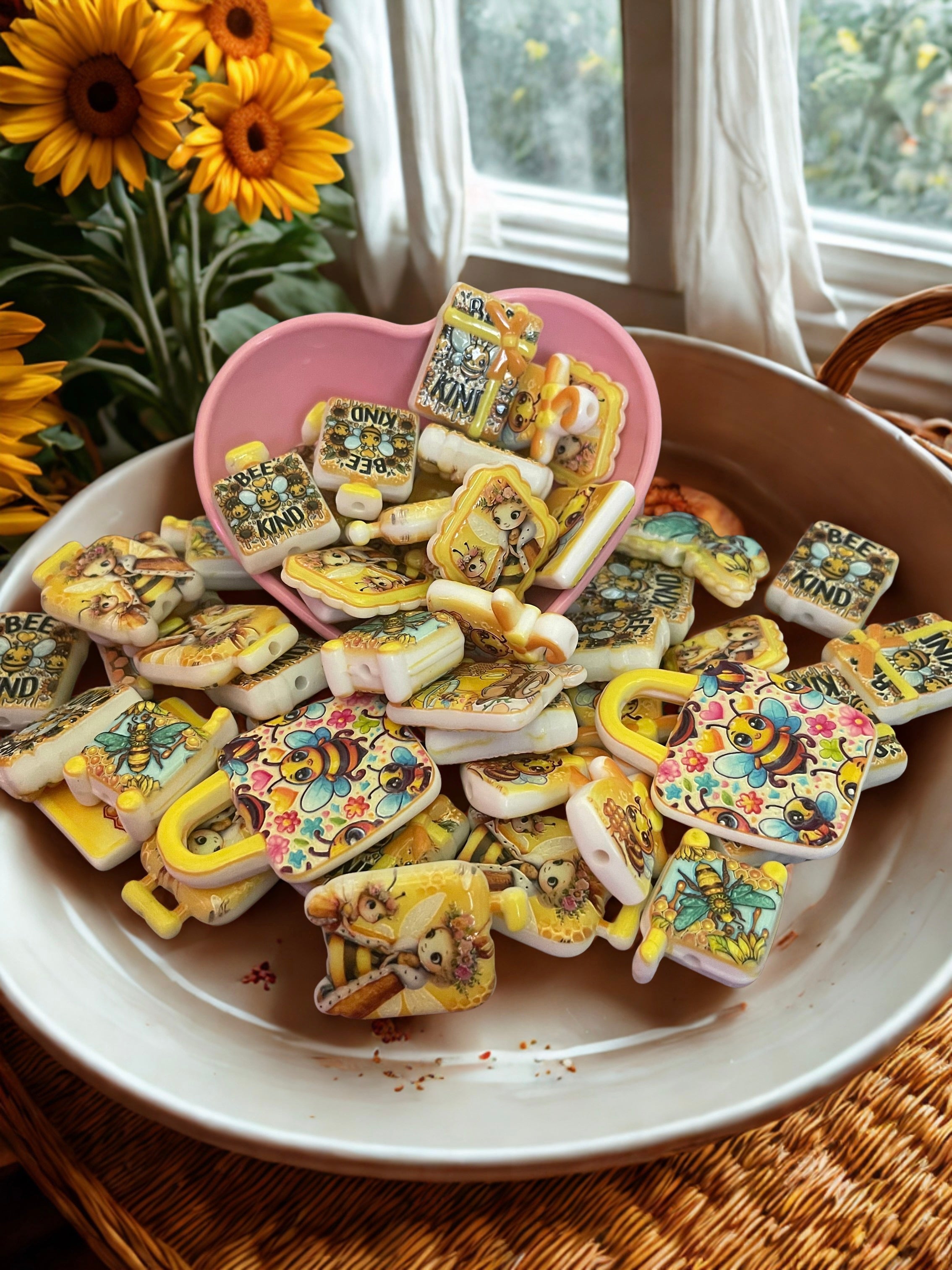 Honey bee bead charms in pink heart bowl with sunflowers
