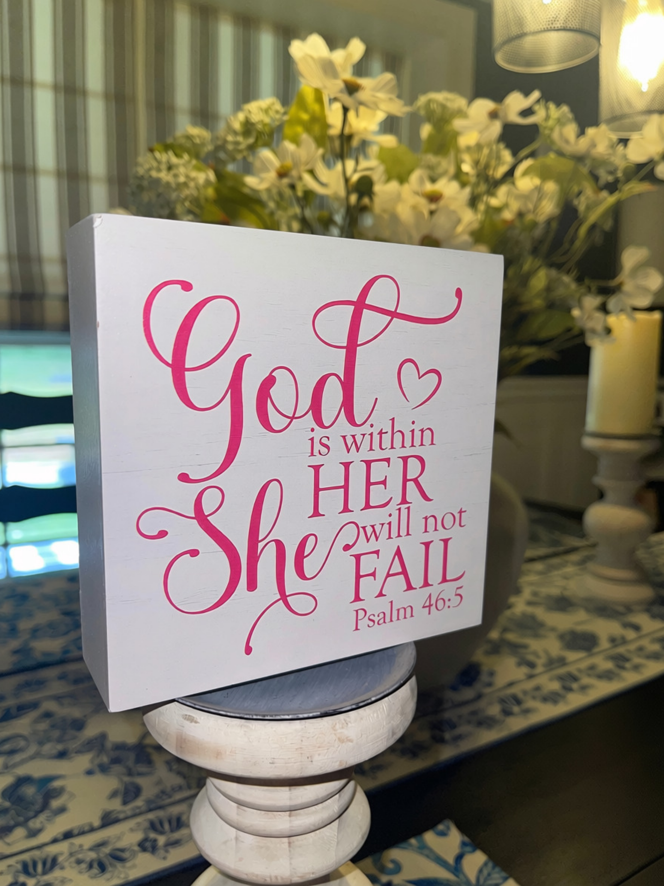 Psalm 46:5 sign displayed on white pedestal candleholder in home interior