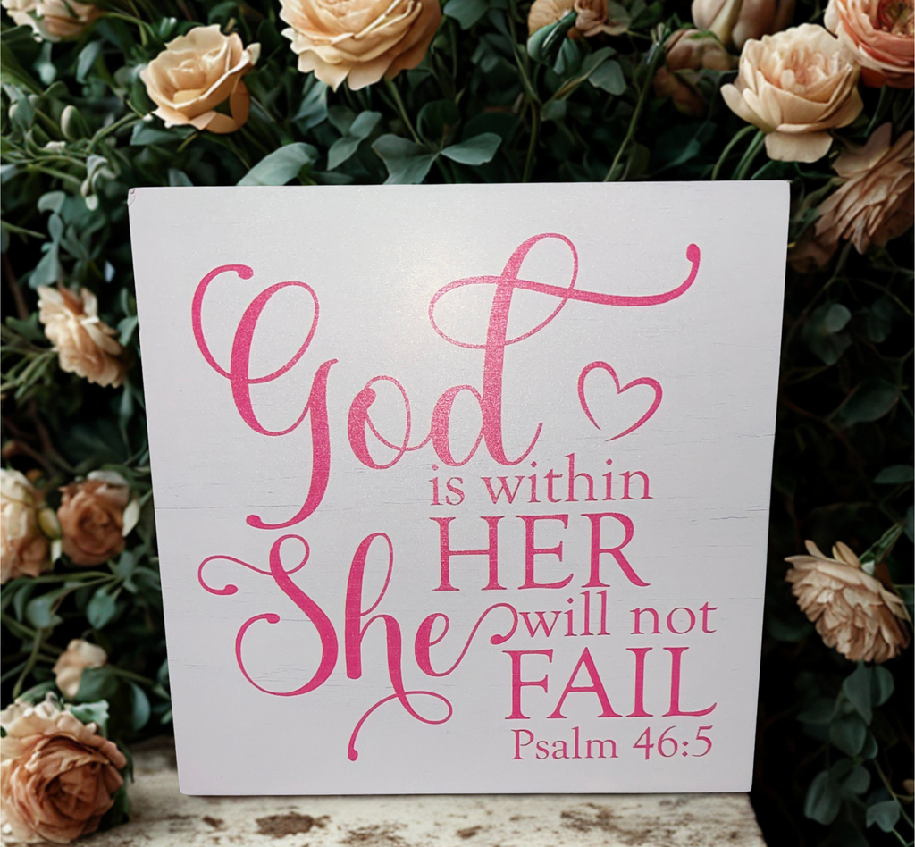 Psalm 46:5 wooden block sign among colorful daisies on a weathered wooden surface