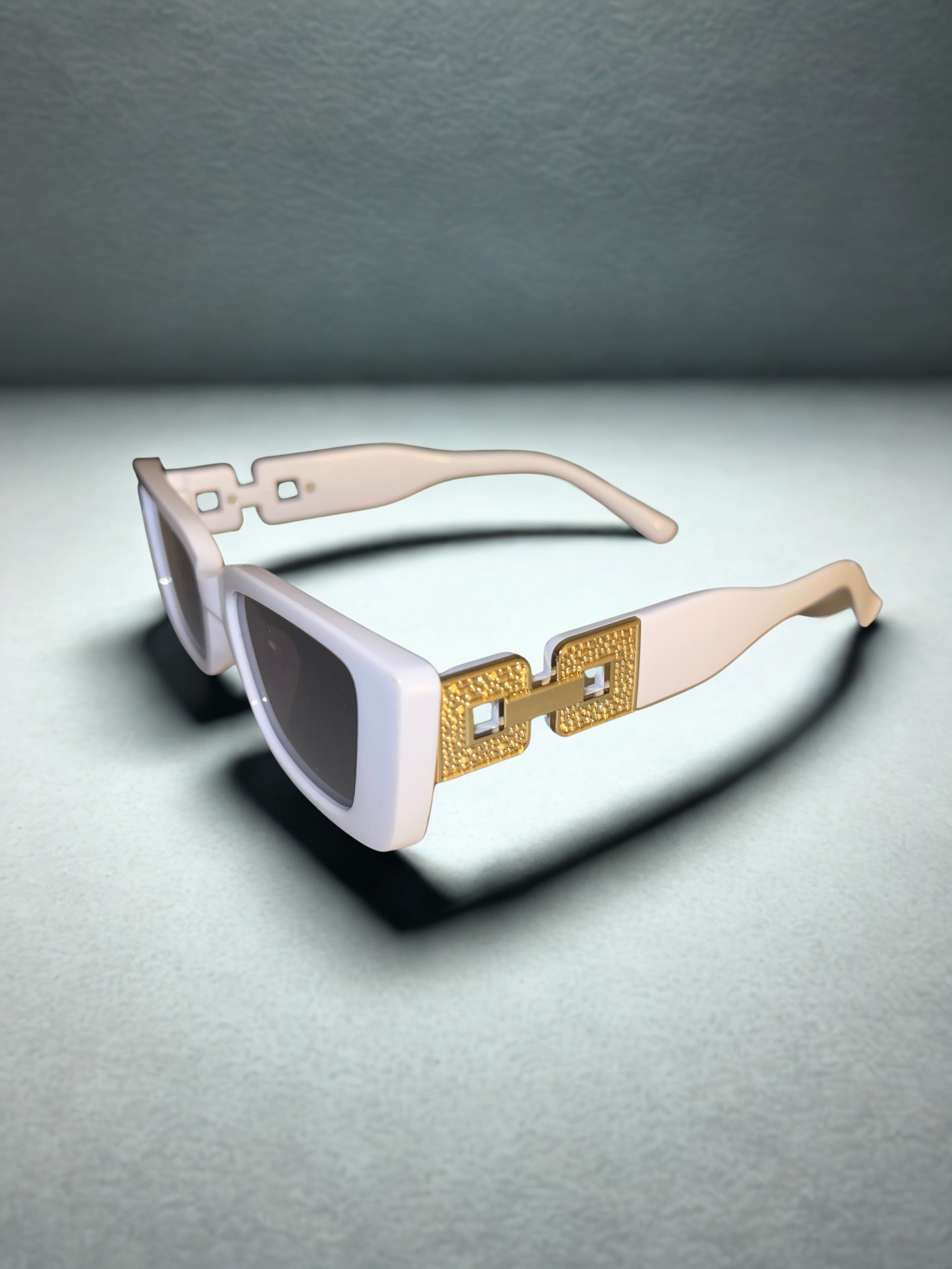 The Prestige Frames white held up showing gold hardware detail