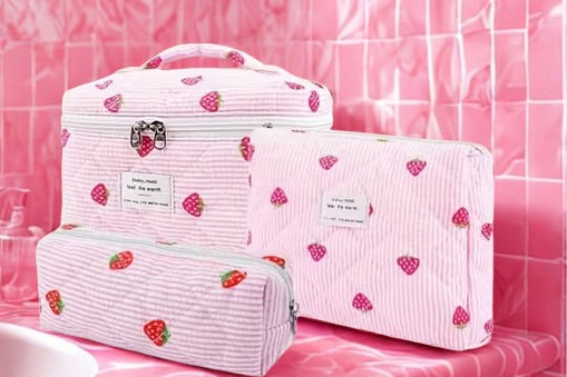 Strawberry quilted makeup bag set in pink — all three pieces displayed together