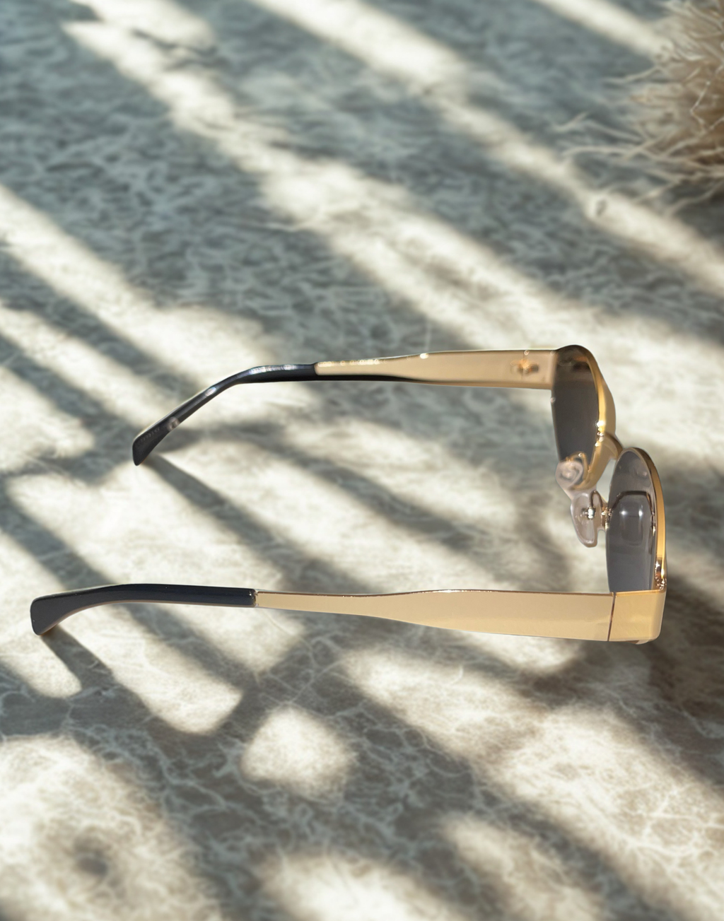 Oval Obsession Sunglasses on beach sand