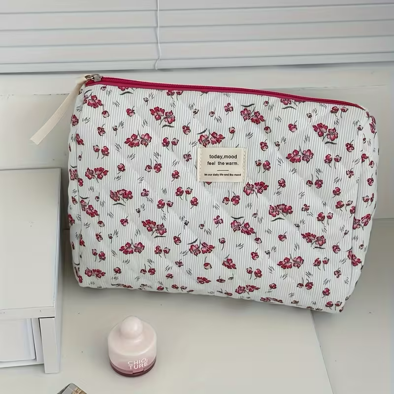 Floral quilted corduroy makeup bag - styled on white surface with flower decor
