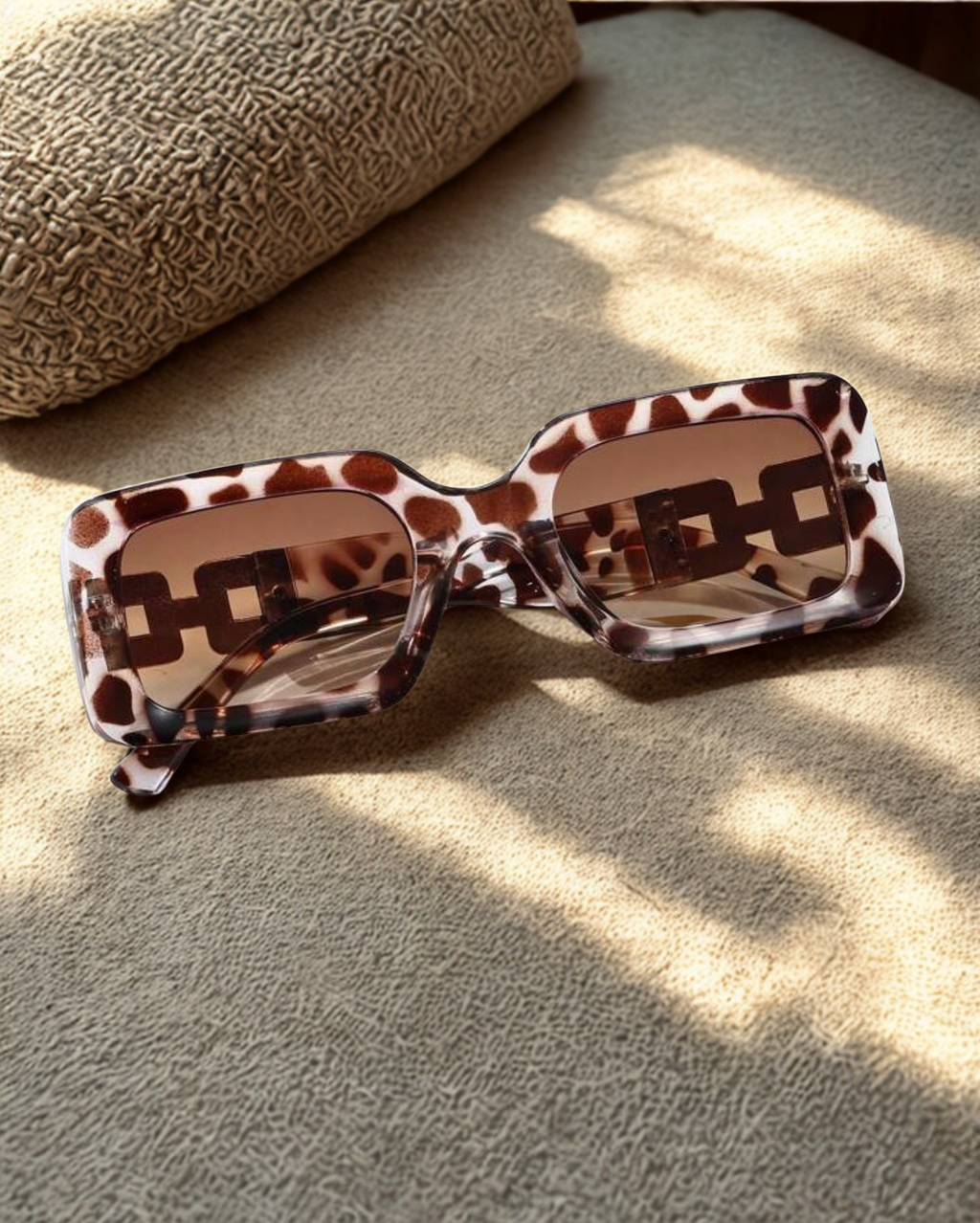 Wild Luxe Rectangle Sunglasses on linen surface in natural light