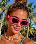 Neon Escape Sunglasses on beach sand close up