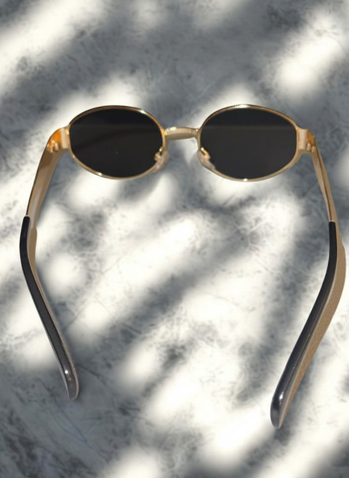 Oval Obsession Sunglasses side view showing gold temple arms