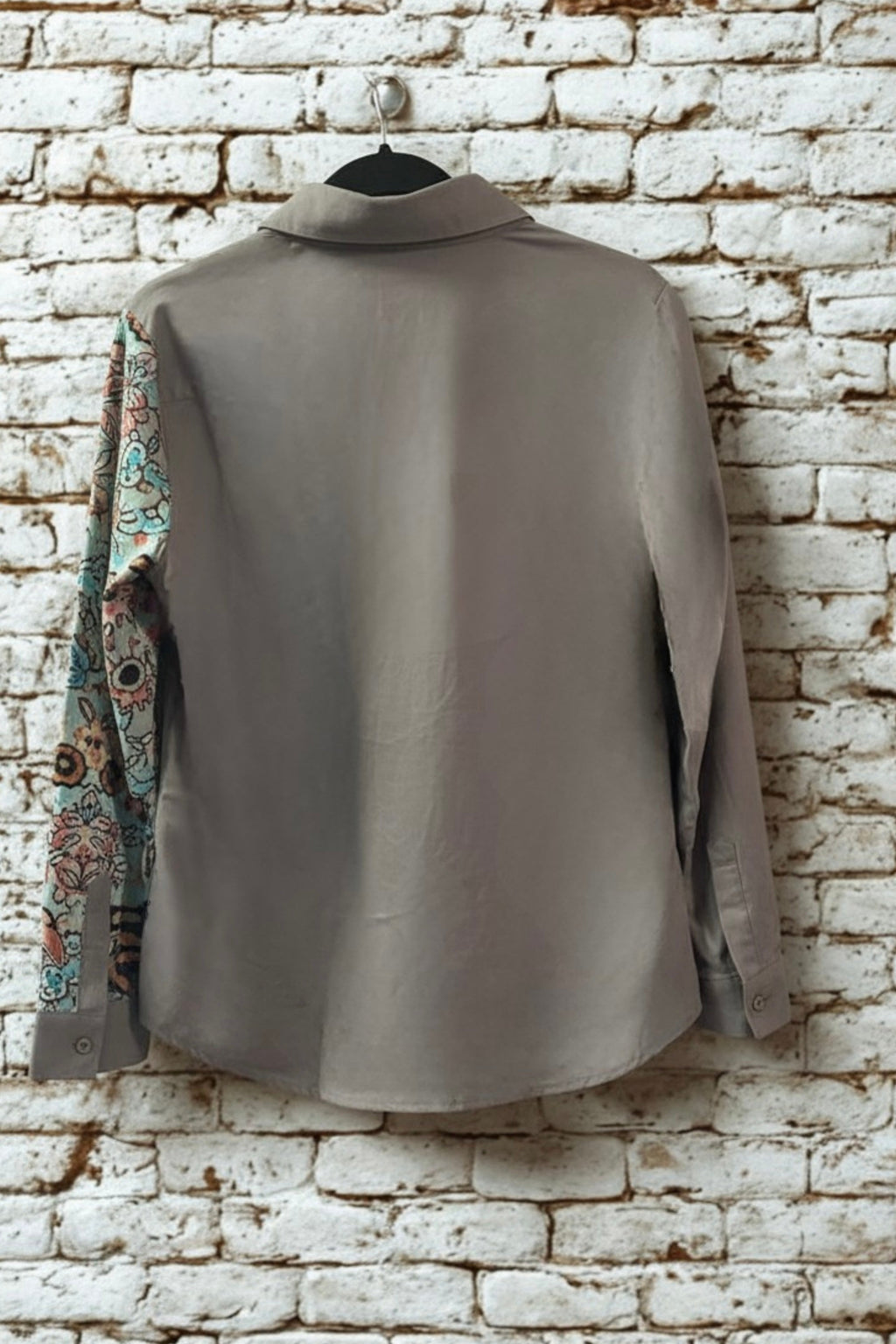 Asymmetric floral art print blouse in white - front view on hanger
