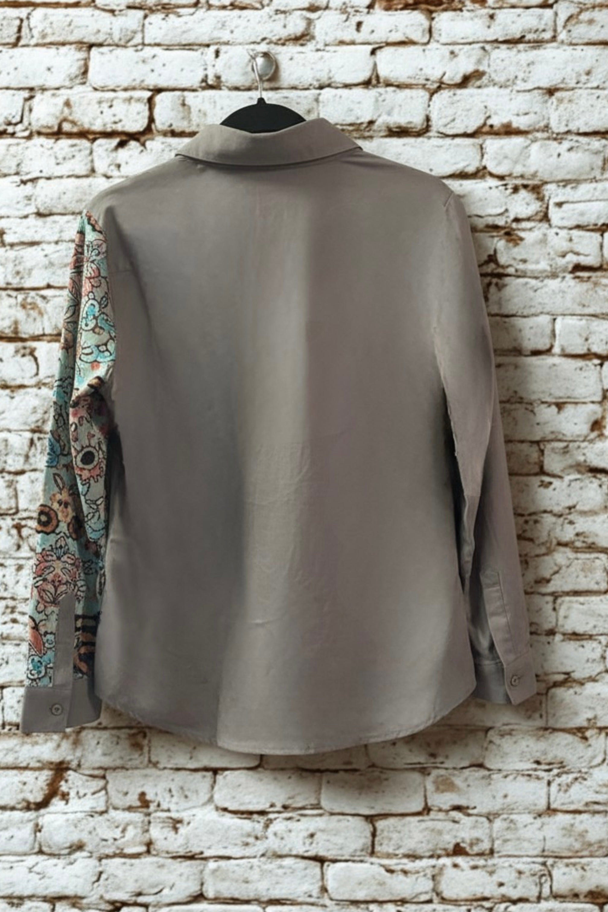 Asymmetric floral art print blouse in white - front view on hanger