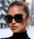 Black Ice Sunglasses worn by model against snowy winter backdrop