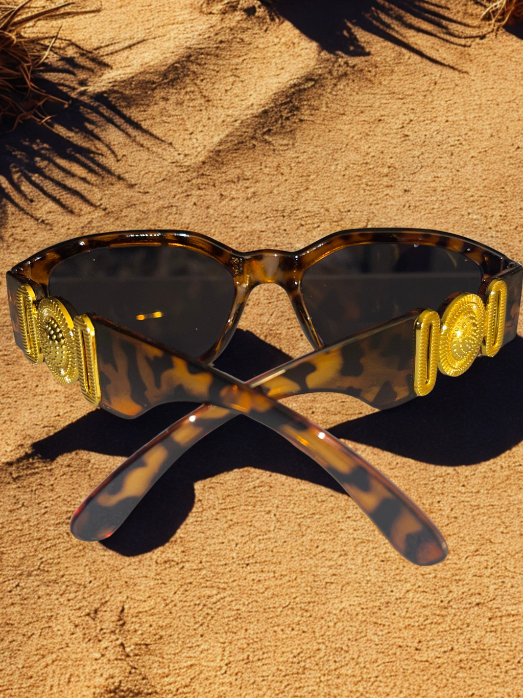 The Versailles Frames leopard print side view on sand