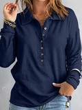 Loose lapel buttoned top worn - navy blue lifestyle front detail