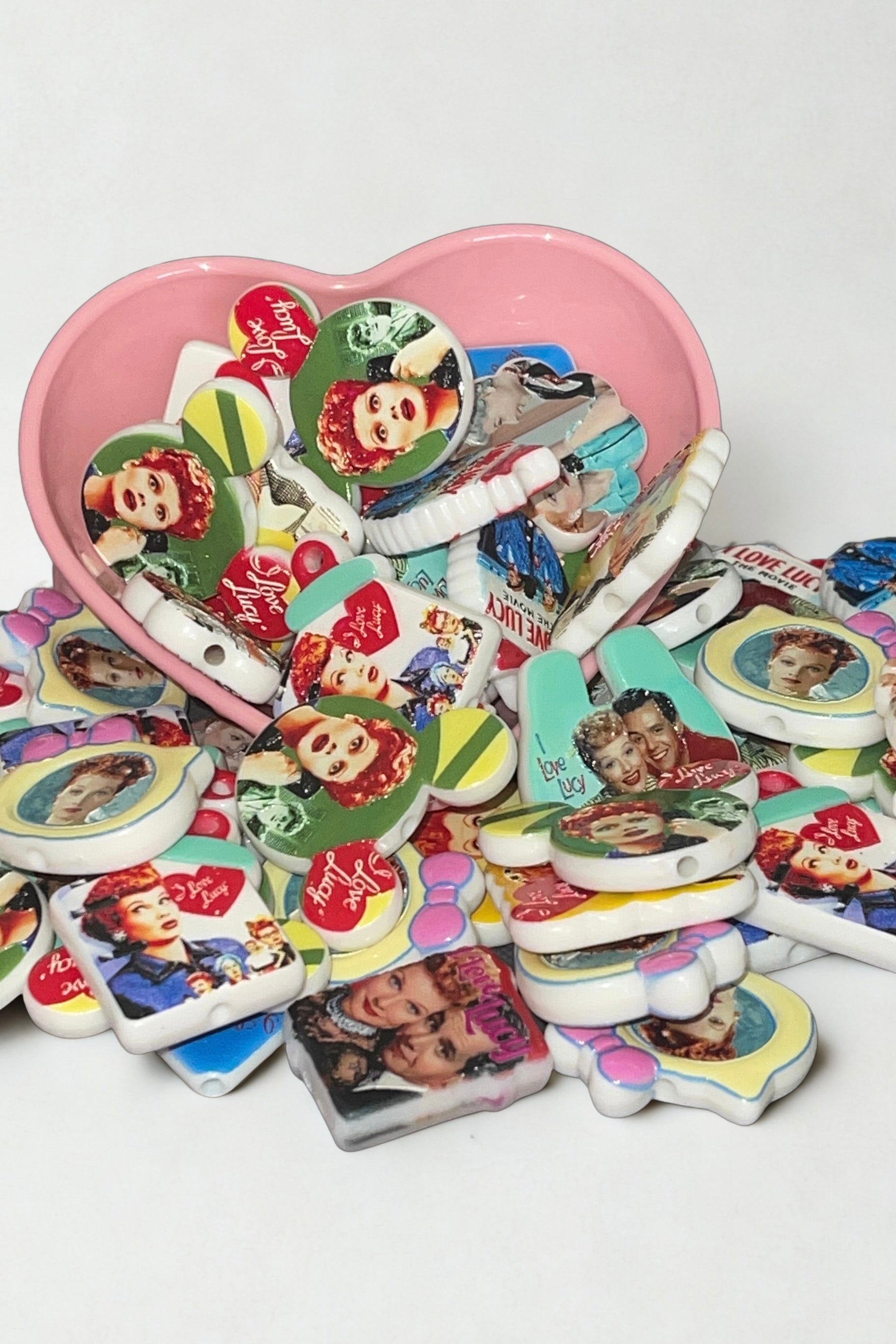Retro TV star bead charms pastel mix in pink heart bowl white background