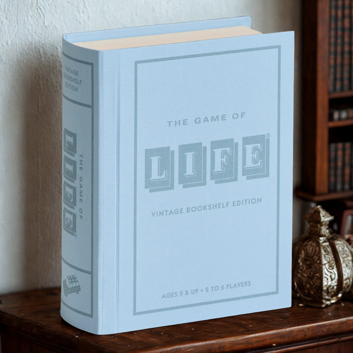 The Game of Life Vintage Bookshelf Edition - fabric-wrapped book box in library setting